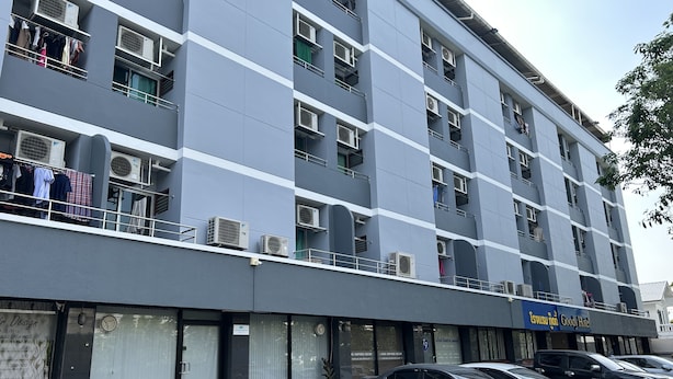 A multi-story building with balconies, air conditioning units, and a Goody Hotel sign. - Goody Hotel (Bangkok)