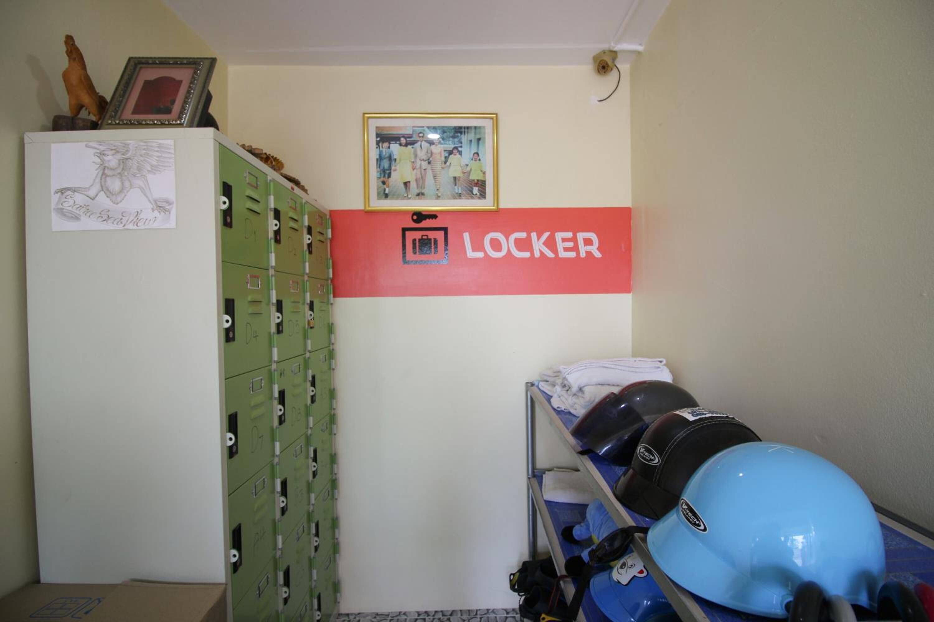 A room with a bunk bed, a locker area, and a framed picture on the wall.