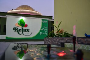 A hotel sign with the Relax Villa logo and a slogan "The World of Privacy". - Relax Villa Hotel (Samut Prakan)