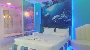 A hotel room with a bed, a shower, and a large mural of marine life. - Relax Villa Hotel (Samut Prakan)