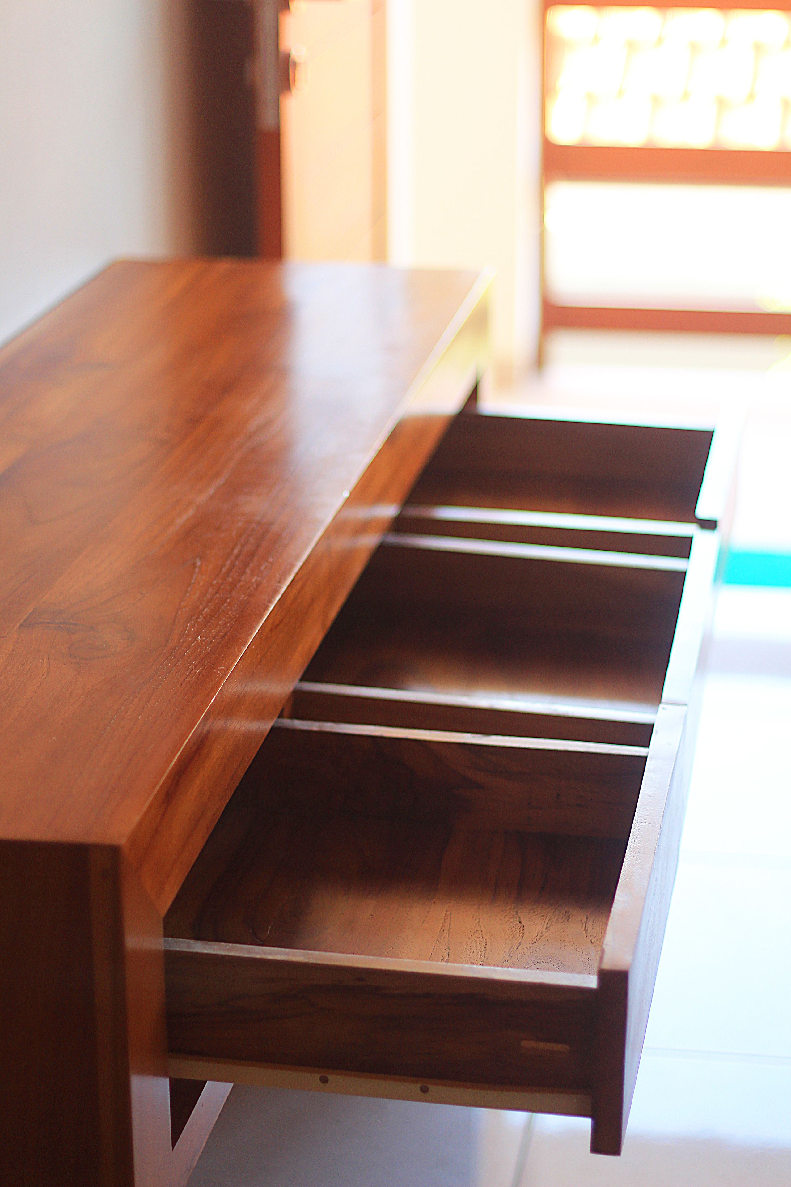 A wooden table with drawers.