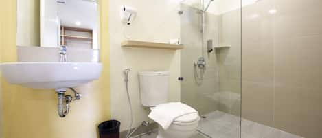 A bathroom with a sink, toilet, and shower.