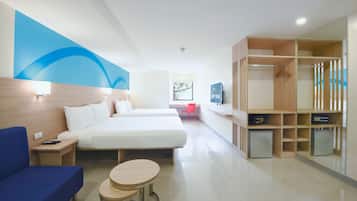 A hotel room with two beds, a desk, a chair, a TV, and a wardrobe.