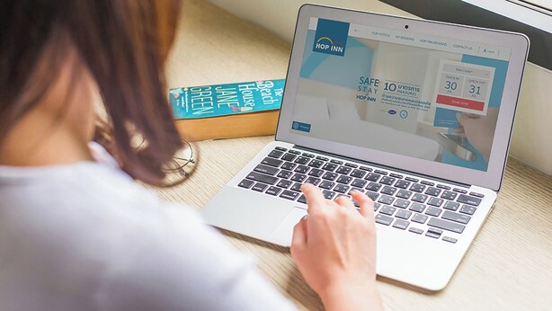 A laptop displaying a hotel booking website with a 'Safe Stay' promotion. - Hop Inn Hotel Alabang Manila (Muntinlupa)