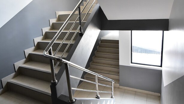 A modern staircase with a metal railing, leading to an upper floor. - WJ Residence at Suvarnabhumi (Bang Phli)
