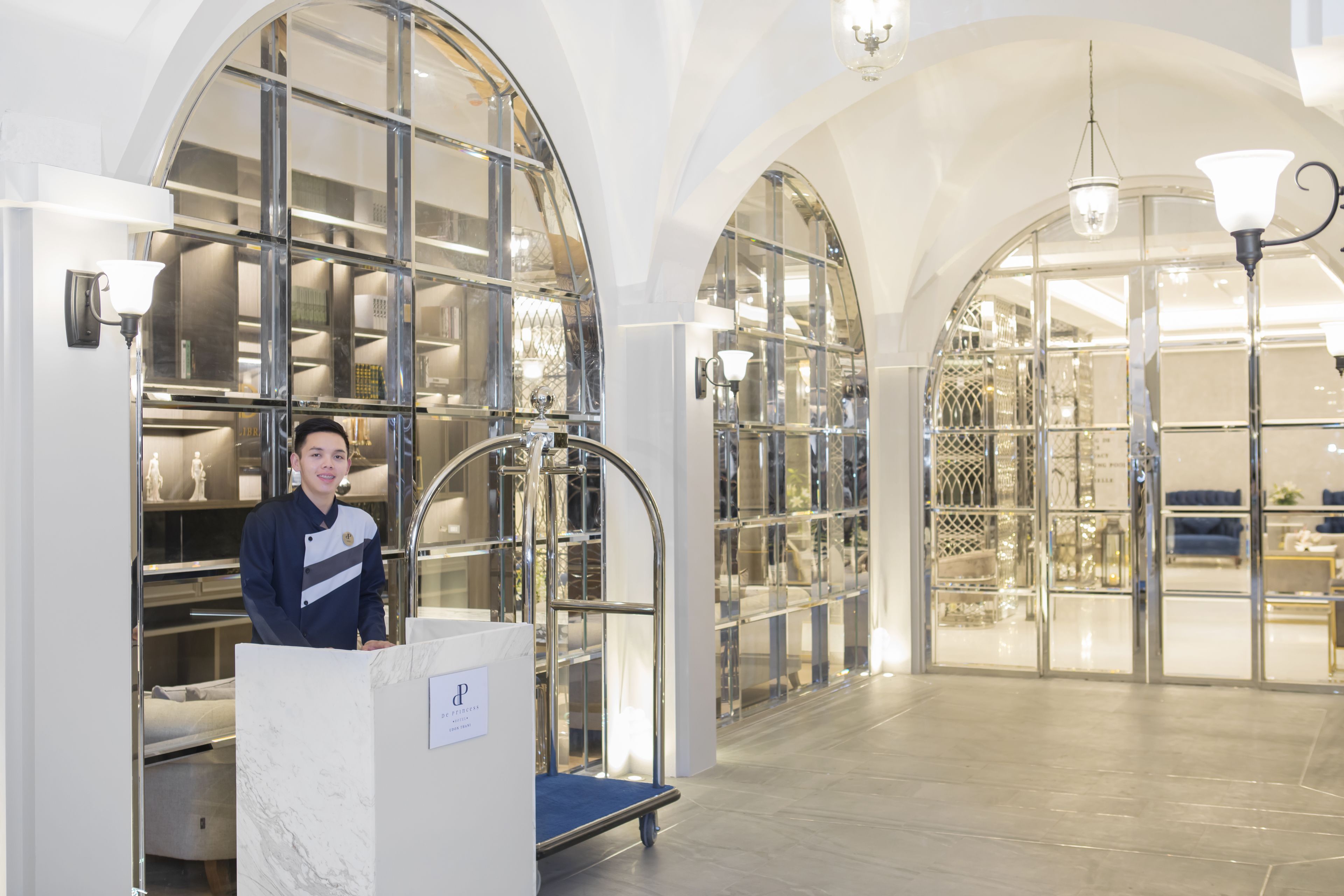 A spacious interior with arched ceilings, a central display area, and a seating area.