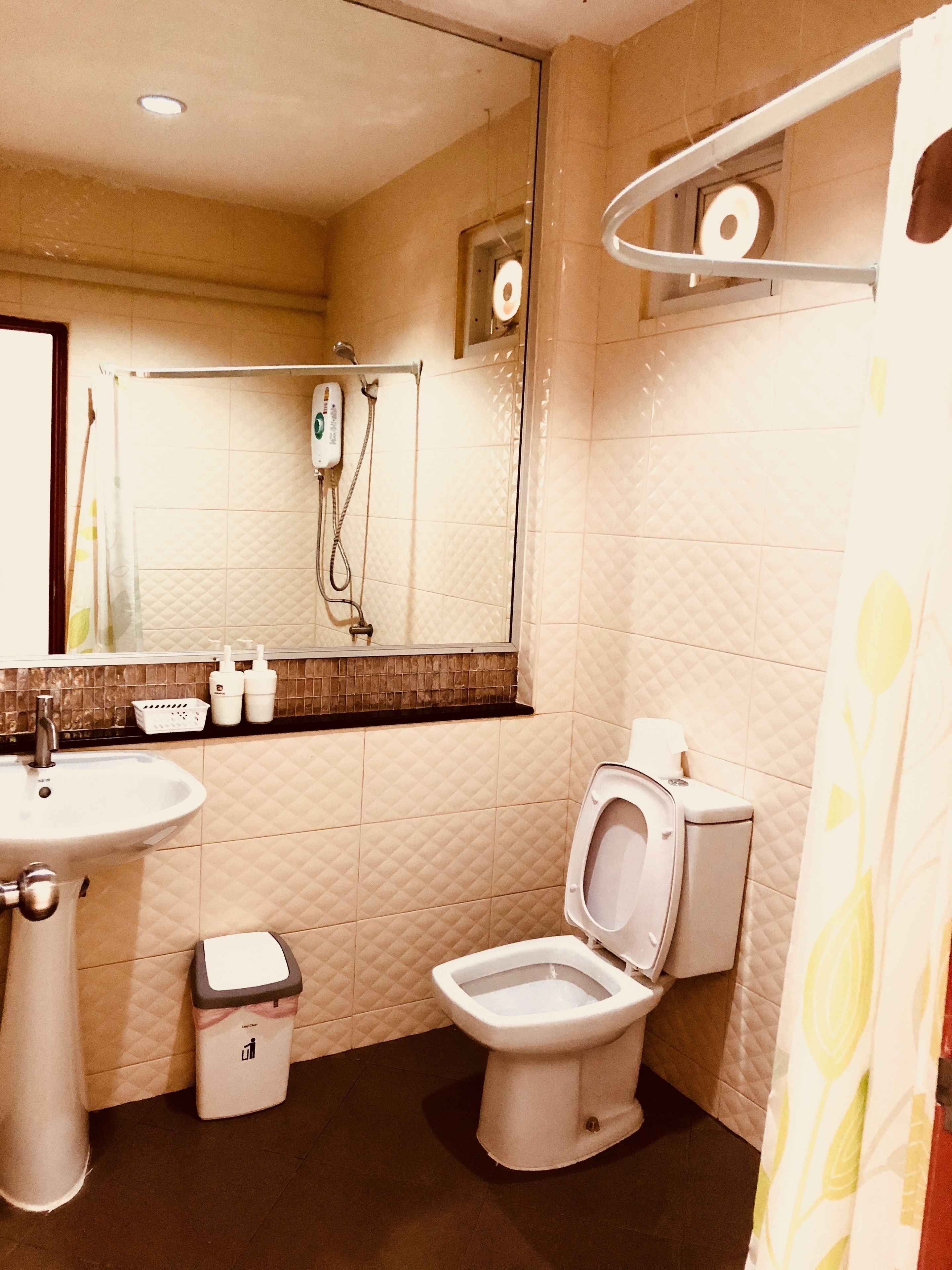 A bathroom with a sink, toilet, and shower.
