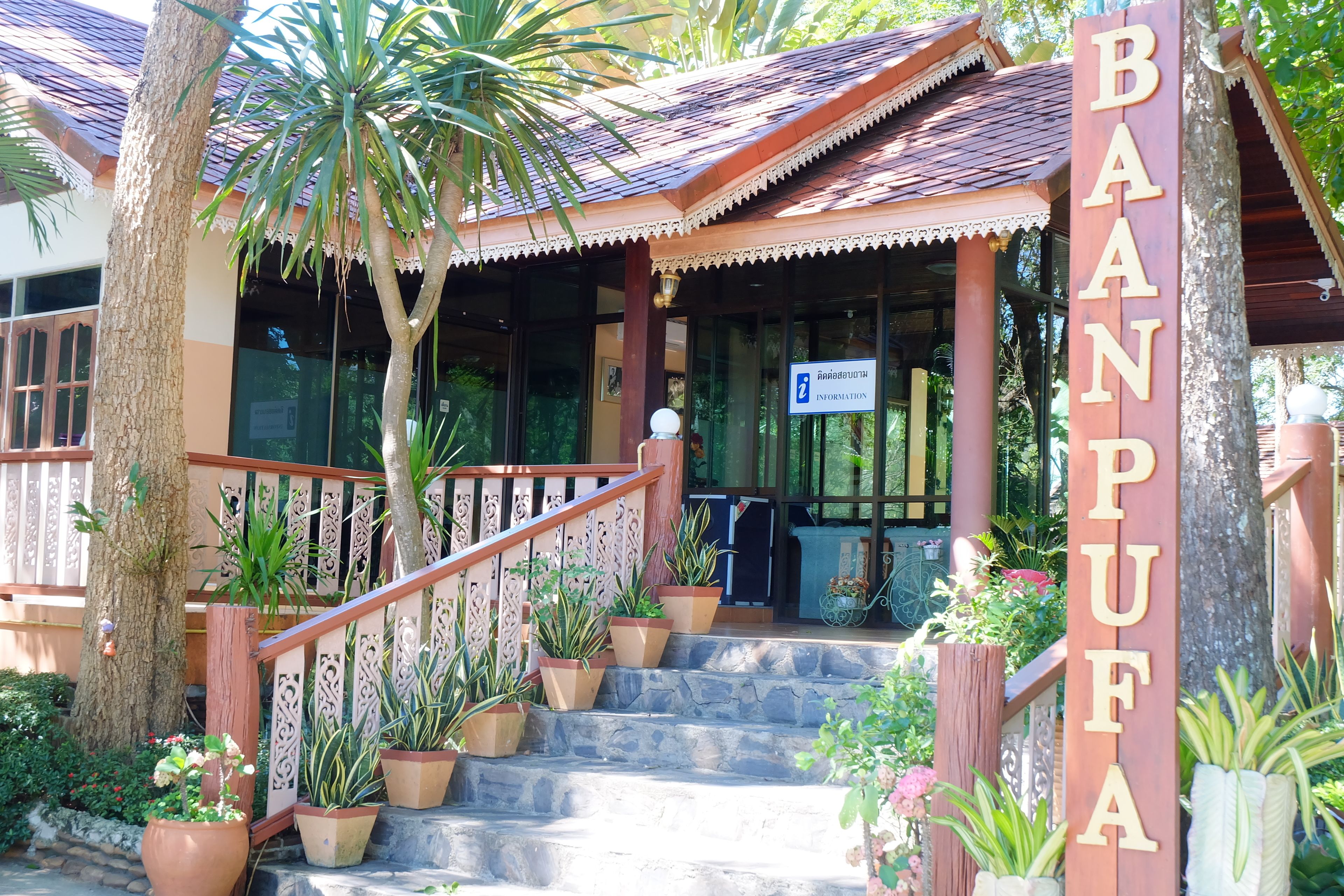 A traditional wooden building with a sign reading "BAANPUFA".
