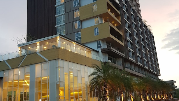 A modern hotel building with multiple floors, large glass windows, and a prominent sign reading "THE VISTA HOTEL". - The Vista Hotel (Sadao)