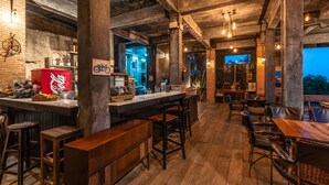 A rustic bar area with wooden furniture, a bar counter, and a visible Coca-Cola cooler.