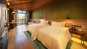 A hotel room with two beds, a desk, a chair, a nightstand, and a view of the outdoors. - Melia Shanghai Parkside (Shanghai)