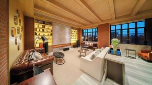A spacious living room with a fireplace, leather sofas, a coffee table, and a large window with a view. - Melia Shanghai Parkside (Shanghai)