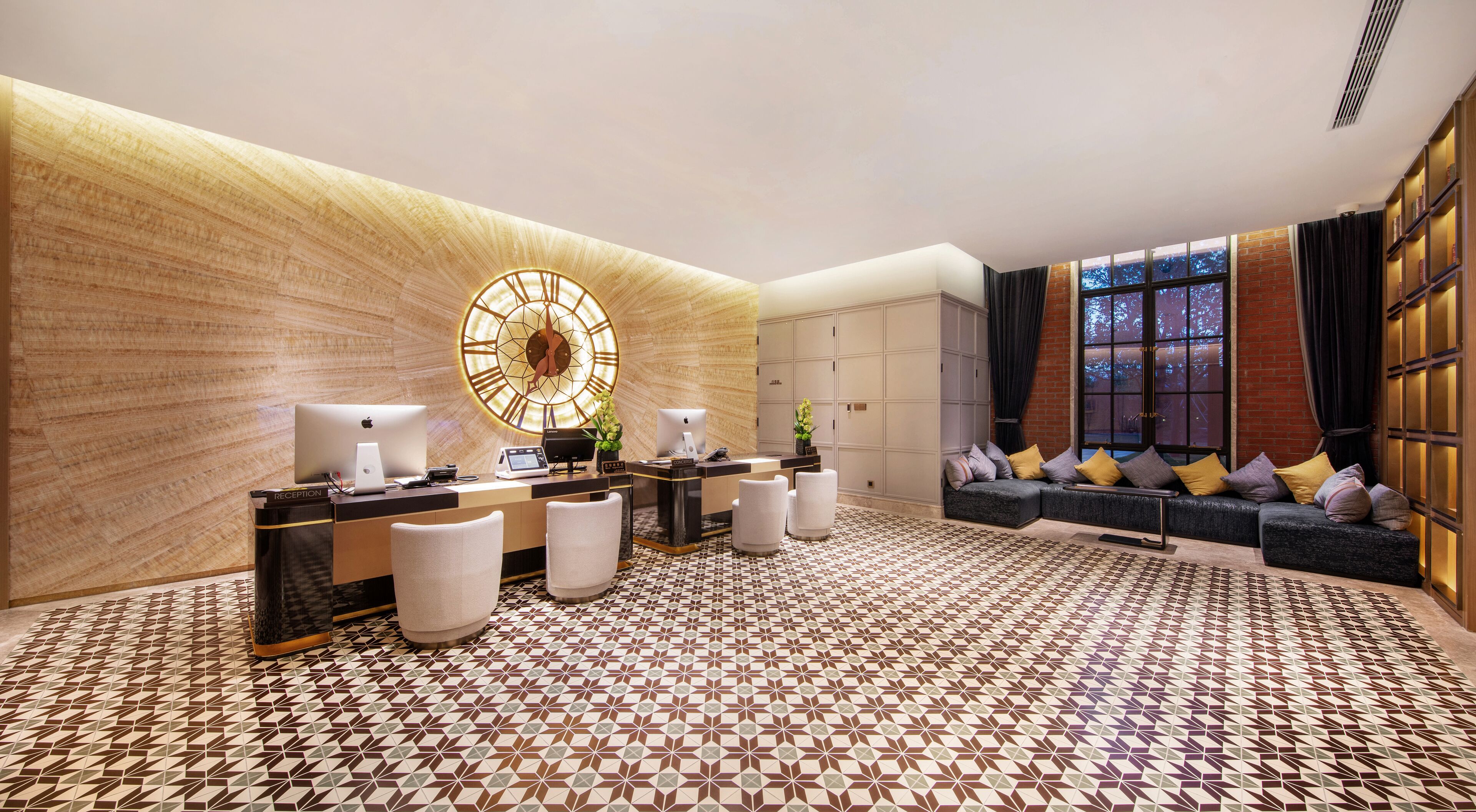 A reception area with a reception desk, seating, and a large wall clock.