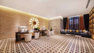 A reception area with a reception desk, seating, and a large wall clock.