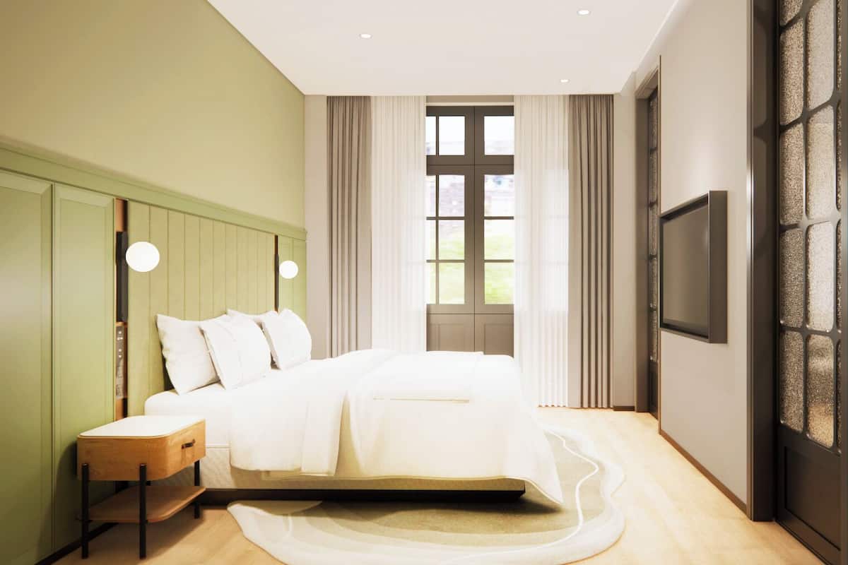 A modern bedroom with a bed, bedside tables, a TV, and a large window with curtains.
