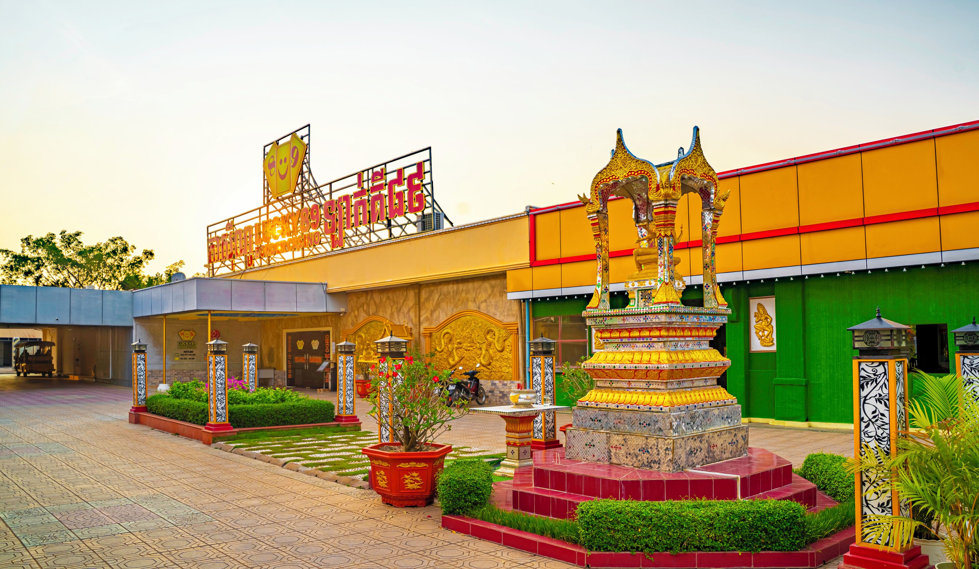 A traditional building with a large golden statue in the courtyard.