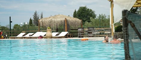 Seasonal outdoor pool, open 11:00 AM to 7:00 PM, pool umbrellas