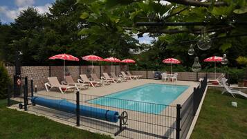 Seasonal outdoor pool, open 9:00 AM to 6:00 PM, pool umbrellas