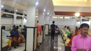 A spacious hall with rows of seating, a central aisle, and a ceiling with recessed lighting. - Hotel City Palace (Nashik)