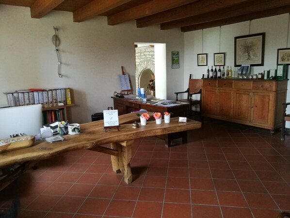 Un comedor rústico con una mesa de madera, sillas y un aparador con botellas.