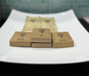 Three brown boxes with tree logos and text on a white tray. - Hotel Concordia (Targu Mures)