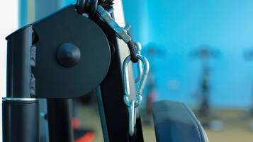 A close-up of a mechanical device with a metal ring and a black rope.
