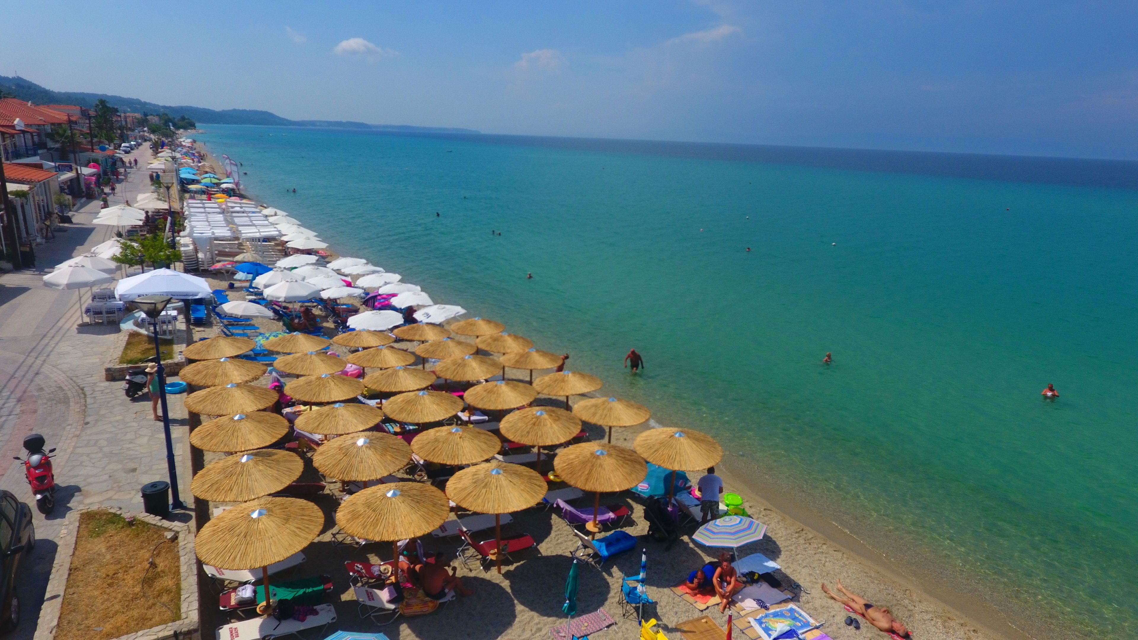 Une plage avec des parasols et des chaises longues.