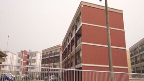 A multi-story building with a red facade and balconies. - Koza Apartment (Lagos)