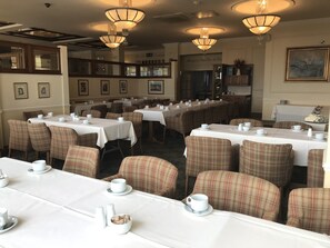Enjoy meals in a warm and inviting dining area with comfortable seating and ample space for groups.