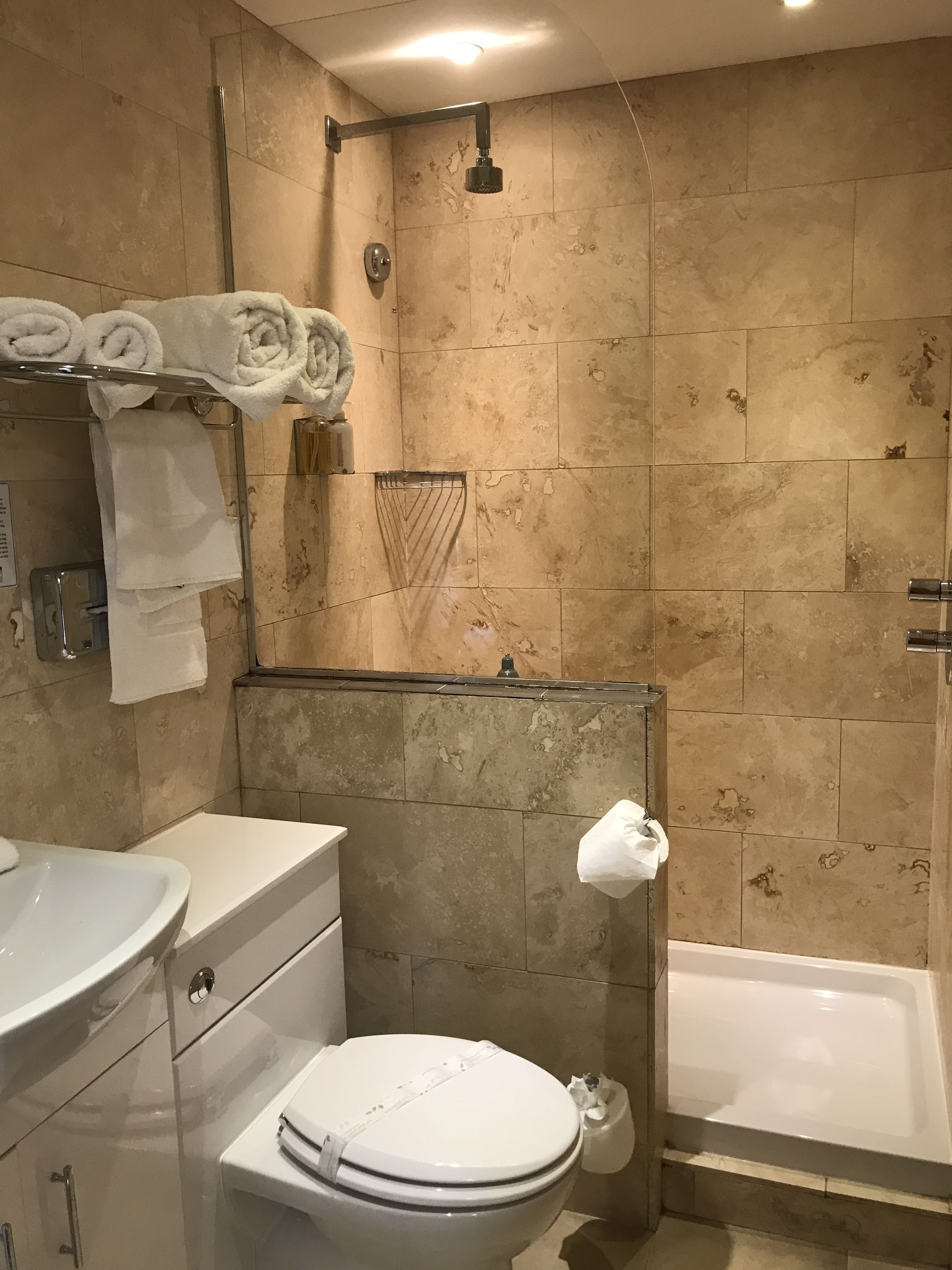 A bathroom with a bathtub, toilet, and sink.