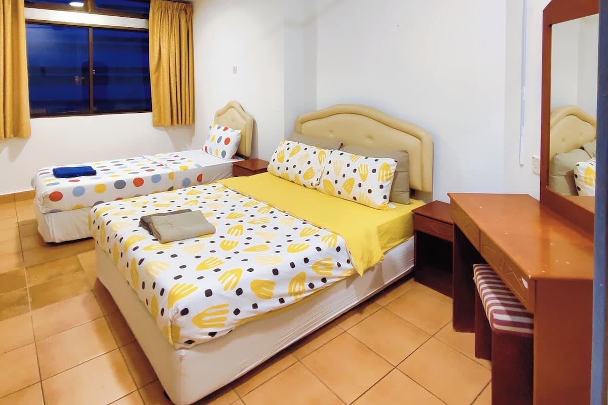 A hotel room with a bed, two bedside tables, a nightstand, a mirror, and a window with curtains.