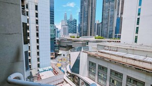 A high-rise building with a modern architectural design, featuring a prominent glass facade and a series of balconies. - Pavilion Fahrenheit 88 - AJ home (Kuala Lumpur)