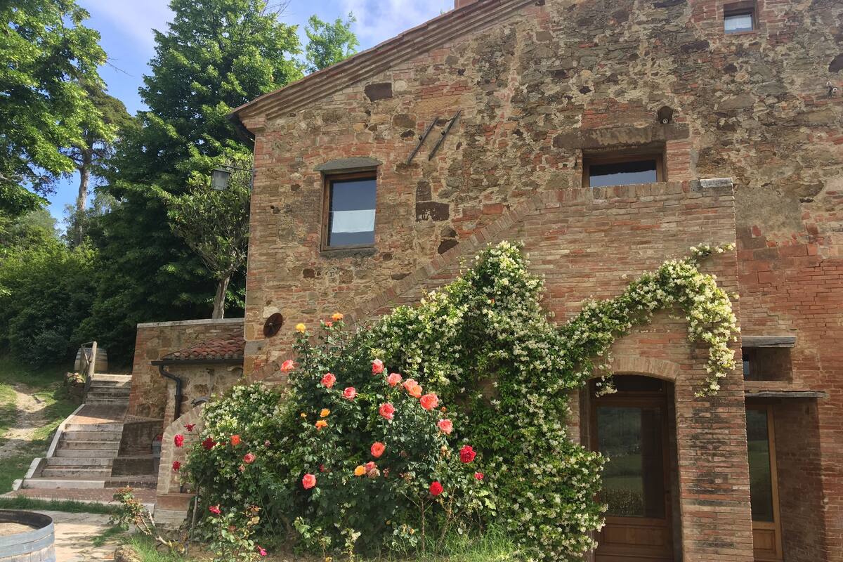 A rustic stone building with a wooden door and a small window.