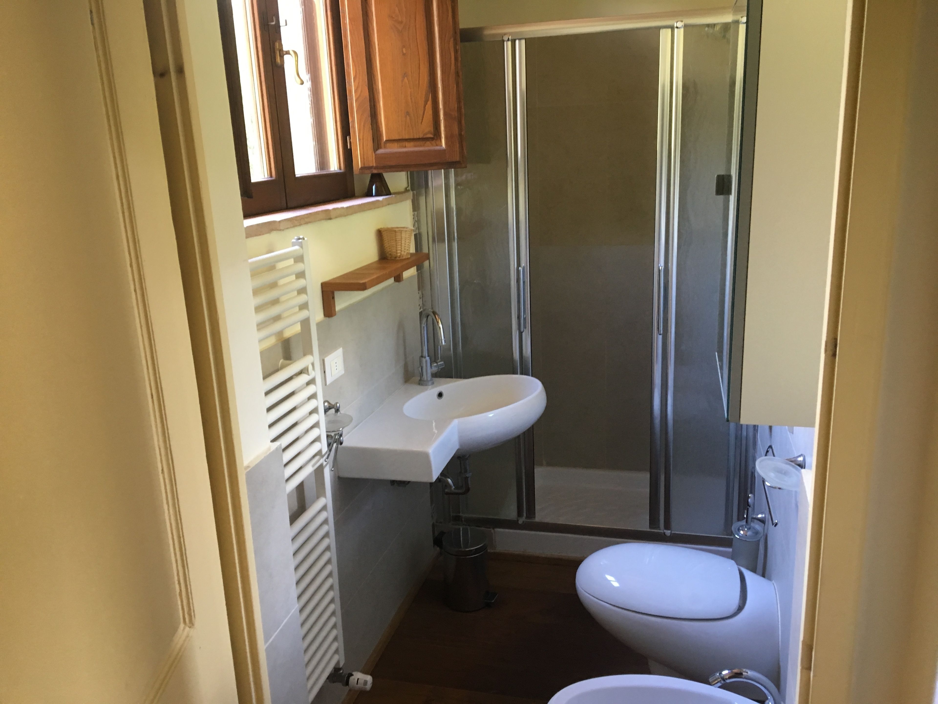 A bathroom with a shower, toilet, and sink.