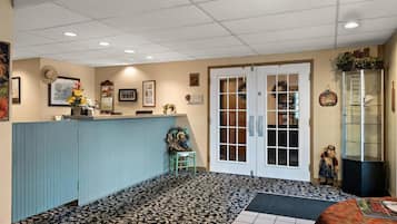 A reception area with a counter, a door with glass panels, and a display cabinet.