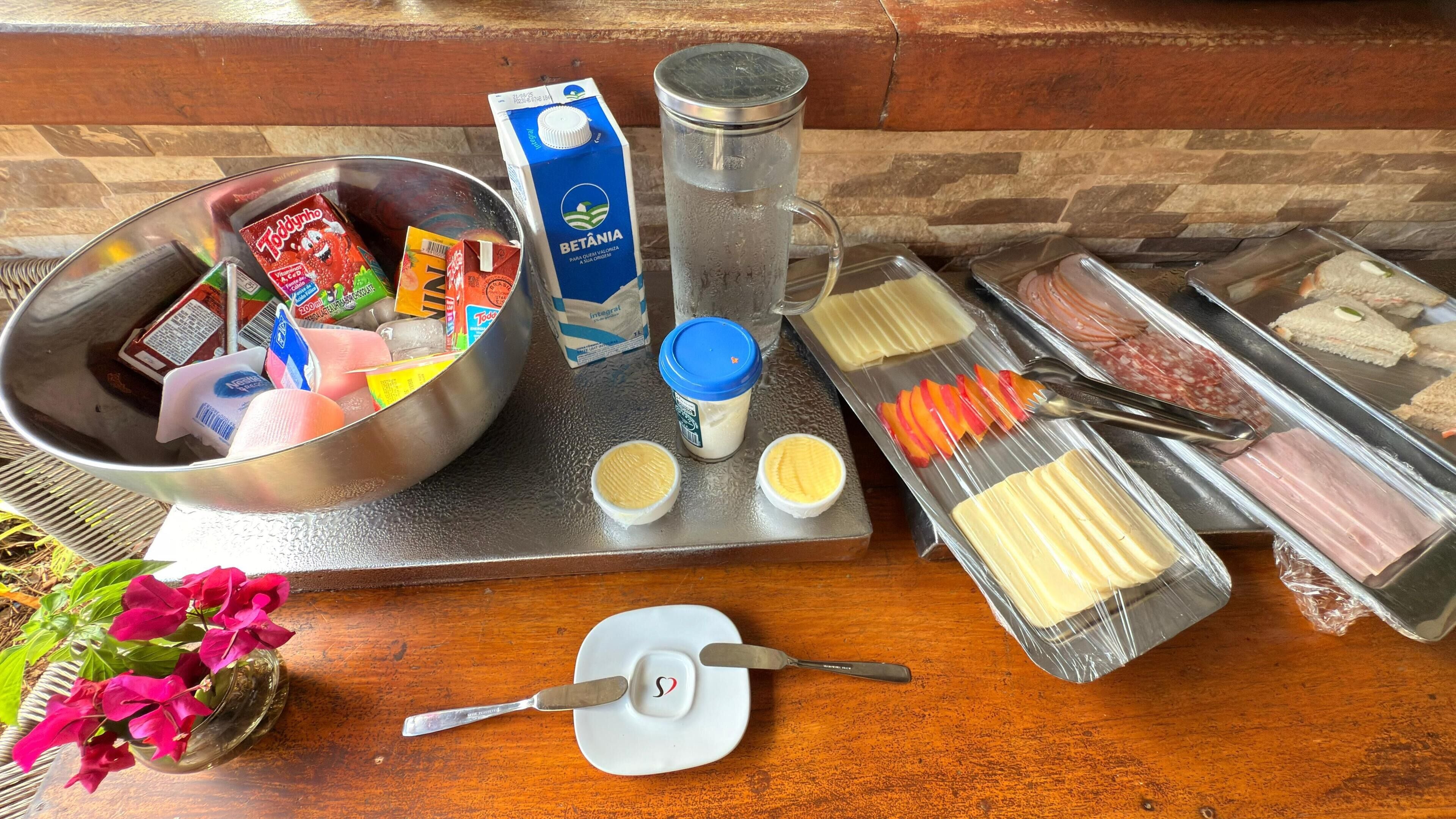 A buffet setup with various food items and condiments.