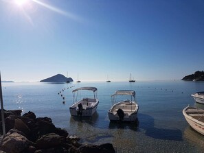 A calm bay with several boats anchored near rocky shores. - Marathon Studios &Apartments (Zakynthos)