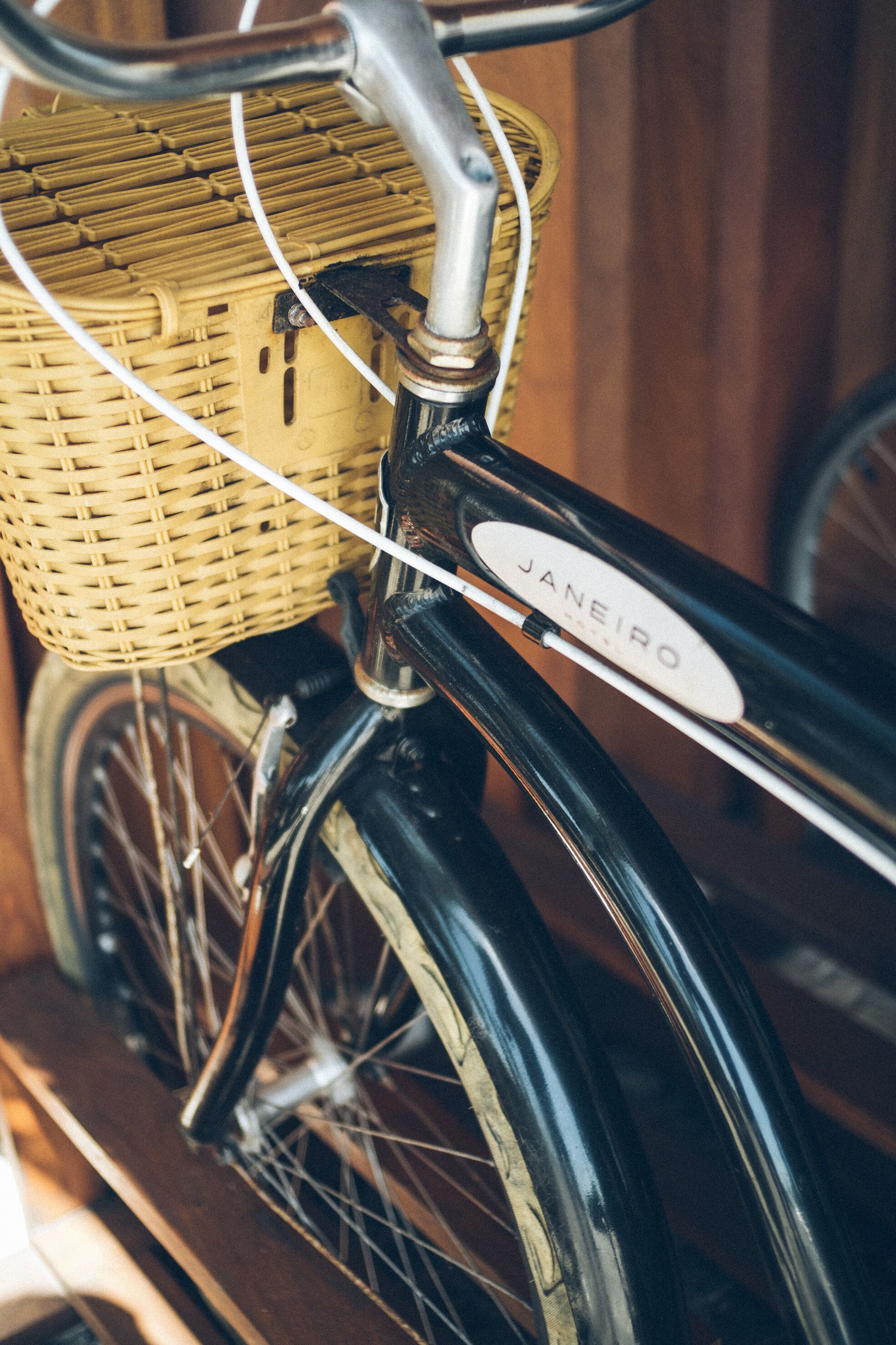 A bicycle with a wicker basket and a label that reads "JANEIRO".