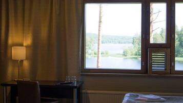 Enjoy a serene view of the lake and forest from this room's large window.