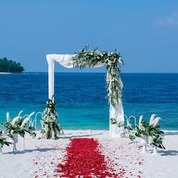 On the beach, white sand, sun loungers, beach umbrellas
