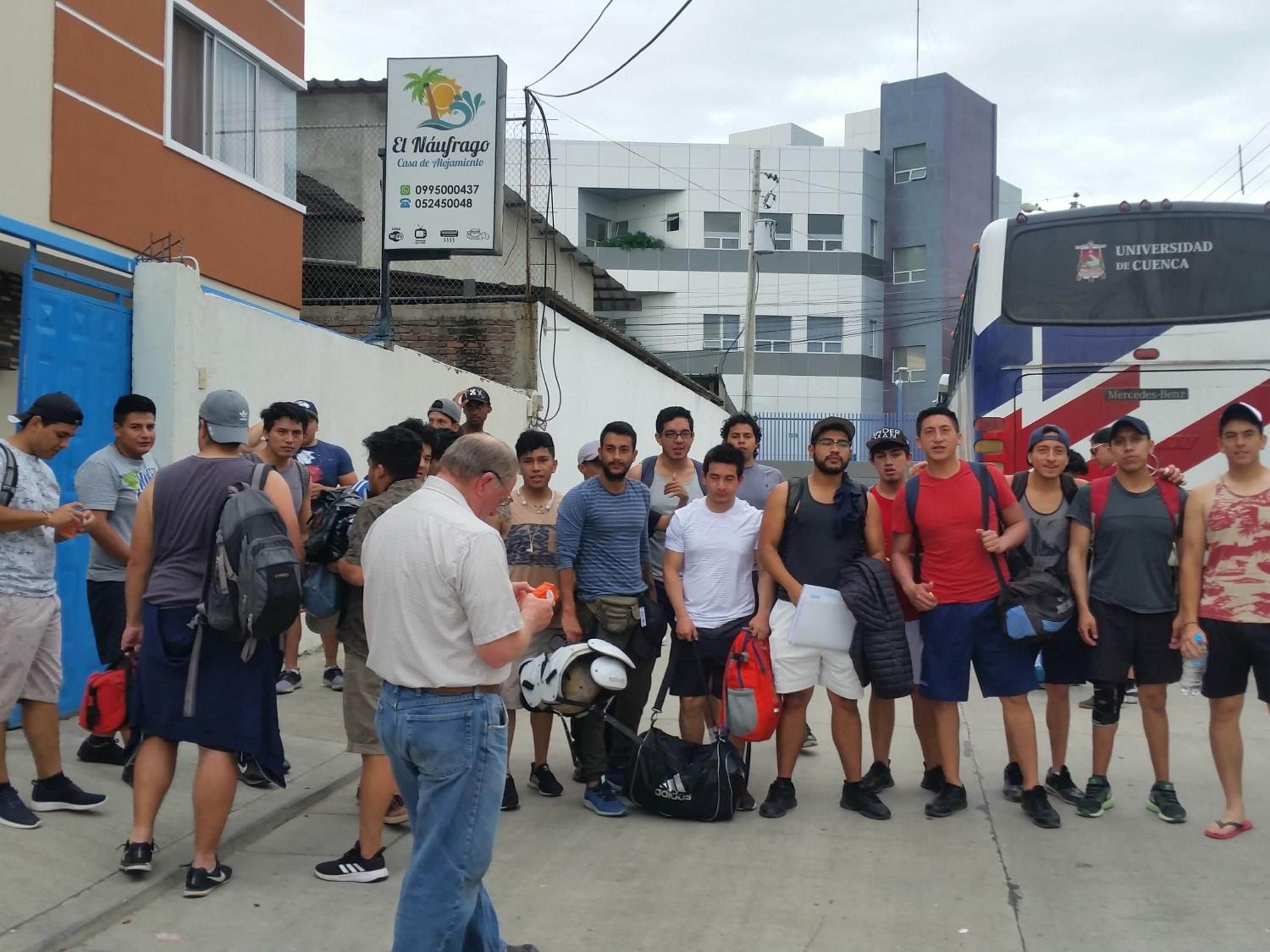 A group of people standing in front of a building with a sign that reads 'El Náufrago Casa de Alquiler.'