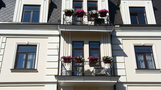 A large, two-story building with a symmetrical facade, multiple windows, and a central entrance with a staircase. - Villa Le Grand (Boryspil)