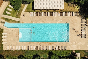 Piscine couverte, piscine extérieure, parasols de plage, chaises longues