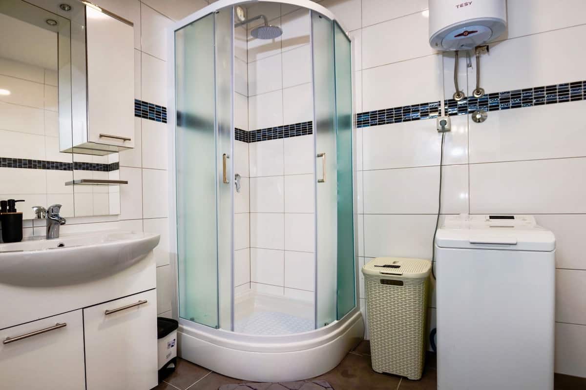 luxury apartment, 2 bedrooms, courtyard area | bathroom | shower, rainfall showerhead, free toiletries, hair dryer