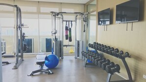 A gym with exercise equipment, a blue exercise ball, and a rack of dumbbells. - Vista Shaw by Charles (Mandaluyong)
