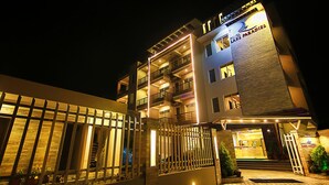A hotel with multiple balconies, a gated entrance, and a well-lit facade at night. - Hotel Lake Paradise (Pokhara)