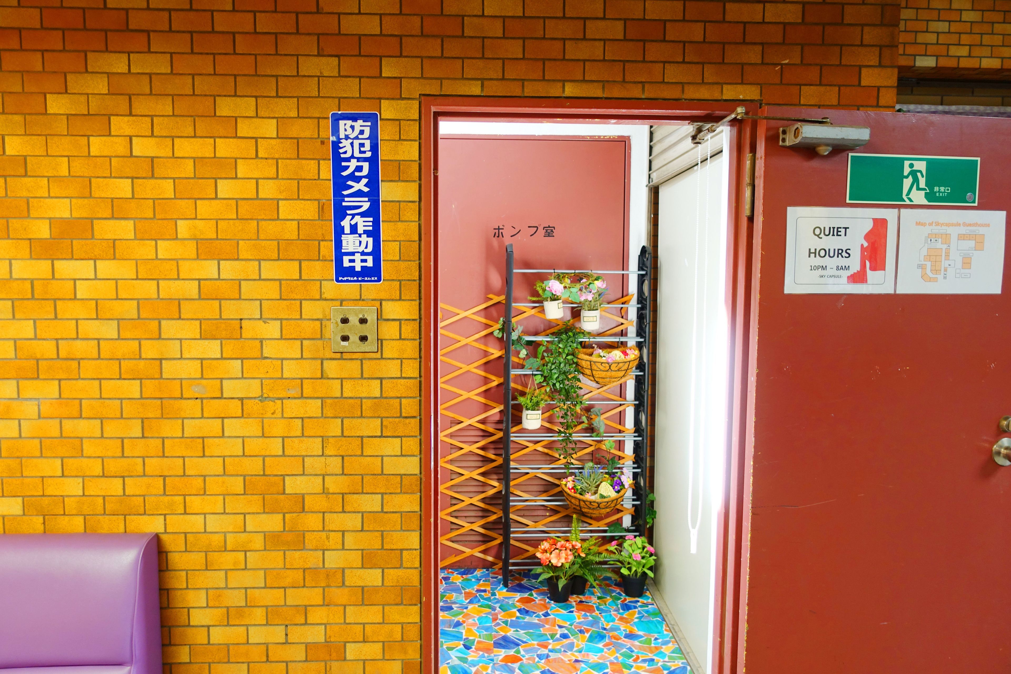 A red door with a sign indicating quiet hours and a map of the hotel.