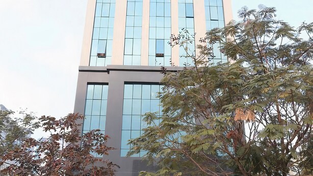 A tall, modern building with large windows and a central entrance. - Granda Central Apartment (Hanoi)