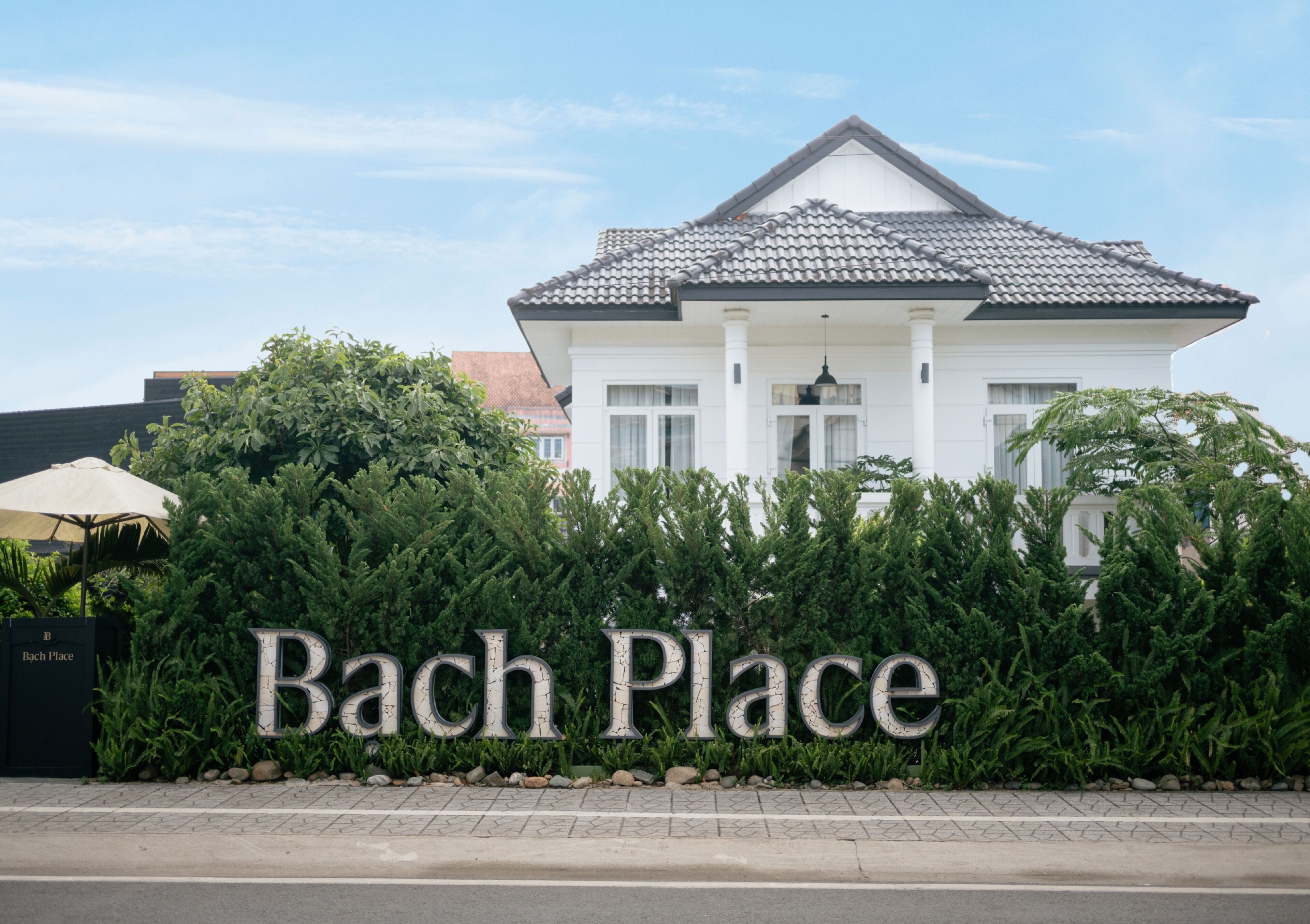 A building with a sign reading "Bach Place" in front.