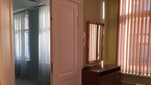 A room with a wooden dresser, a mirror, and a radiator. - Heart of Riga Apartment (Riga)